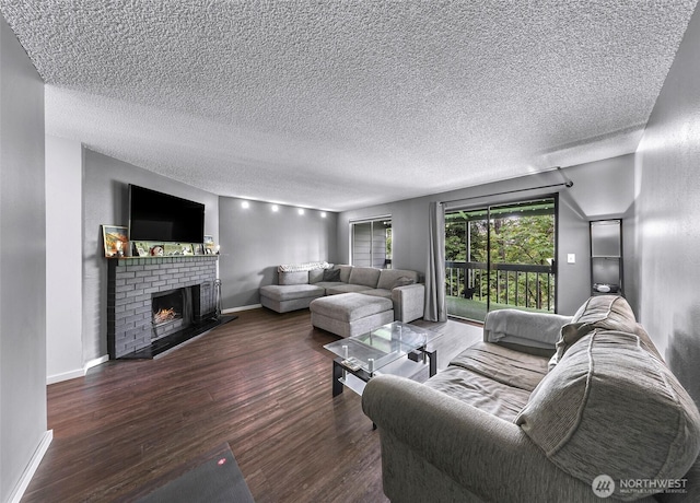 1211 N 8th St Unit 2, Mount Vernon, WA 98273 - living room with wood finished floors, a brick fireplace, and a textured ceiling