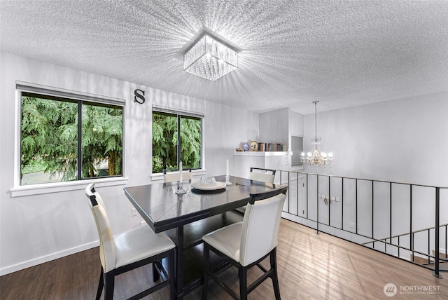 1211 N 8th St Unit 2, Mount Vernon, WA 98273 - dining space featuring a chandelier, a textured ceiling, and wood finished floors