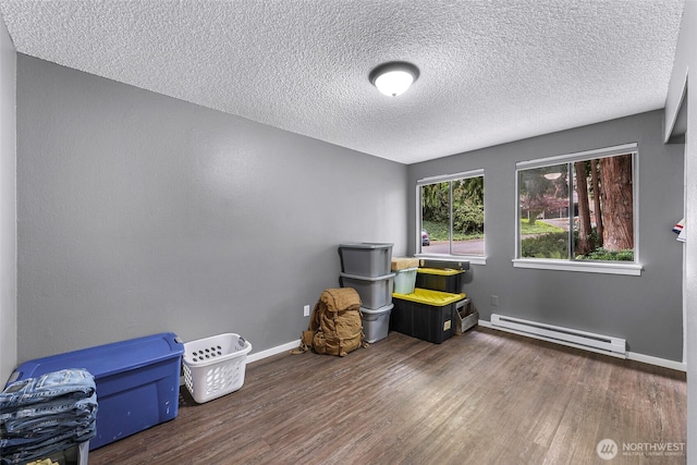 1211 N 8th St Unit 2, Mount Vernon, WA 98273 - spare room with a baseboard heating unit, wood finished floors, and a textured ceiling
