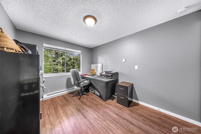 1211 N 8th St Unit 2, Mount Vernon, WA 98273 - home office with baseboard heating, wood finished floors, and a textured ceiling