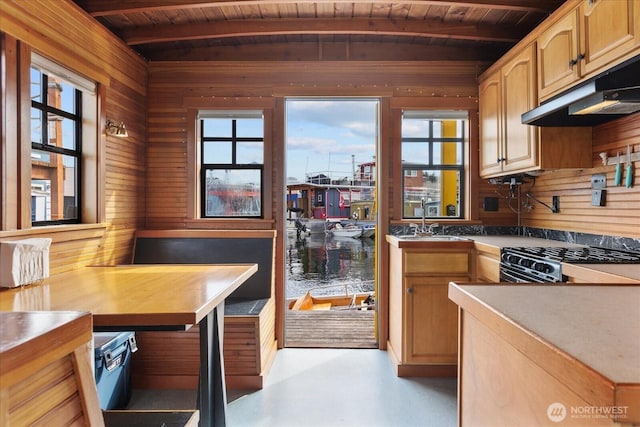 2401 N Northlake Way Unit E7, Seattle, WA 98103 - kitchen with under cabinet range hood, range, a wooden ceiling with exposed beams, wooden walls, and finished concrete floors
