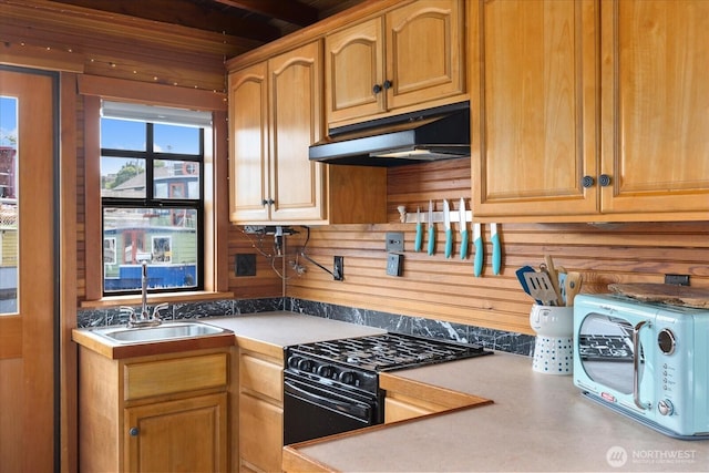 2401 N Northlake Way Unit E7, Seattle, WA 98103 - kitchen with under cabinet range hood, black range with gas stovetop, and light countertops