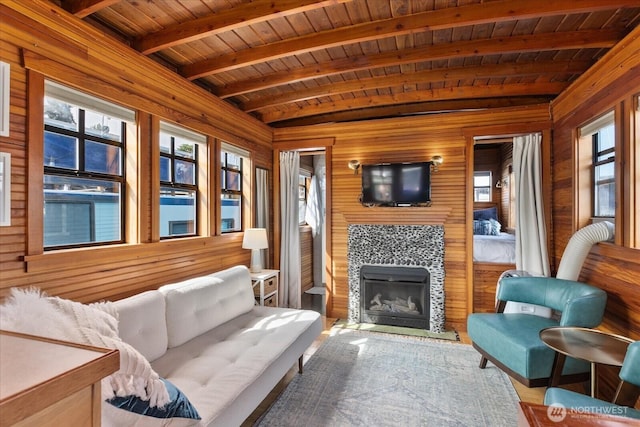 2401 N Northlake Way Unit E7, Seattle, WA 98103 - living area featuring wooden walls, a wood ceiling with exposed beams, and a tile fireplace