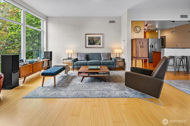 17 W Mercer St Unit 300, Seattle, WA 98119 - living area featuring light wood-style flooring and rail lighting