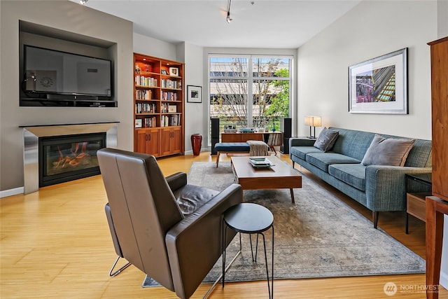 17 W Mercer St Unit 300, Seattle, WA 98119 - living room with light wood-type flooring, a glass covered fireplace, and built in shelves