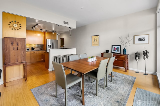 17 W Mercer St Unit 300, Seattle, WA 98119 - dining room featuring rail lighting and light wood-type flooring