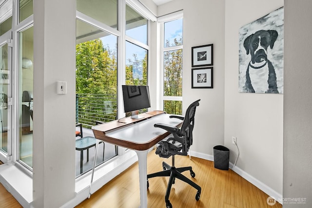17 W Mercer St Unit 300, Seattle, WA 98119 - home office with baseboards and wood finished floors