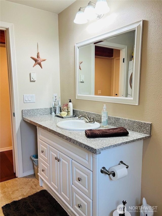 601 Mountain Trail Rd, Brinnon, WA 98320 - bathroom with vanity, washer / clothes dryer, and tile patterned floors