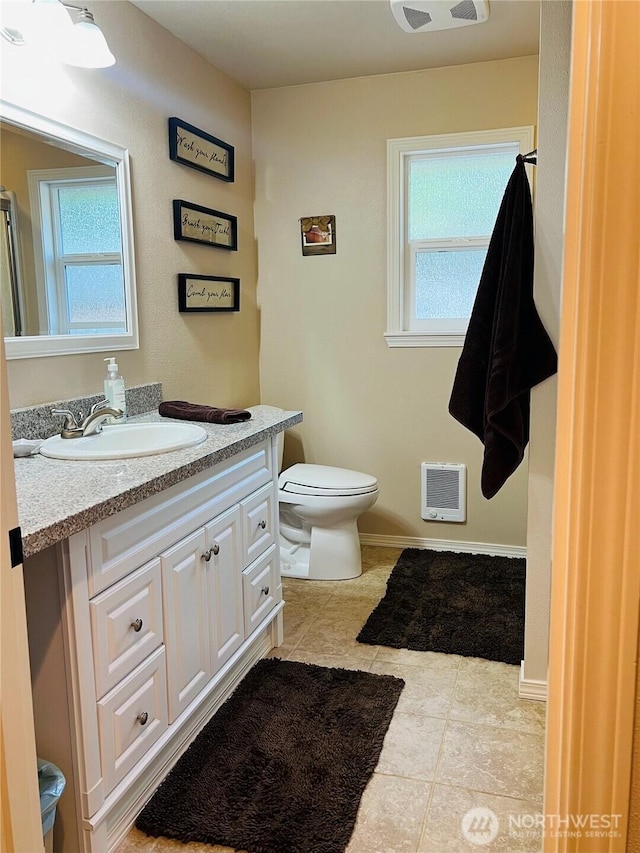 601 Mountain Trail Rd, Brinnon, WA 98320 - bathroom featuring vanity, tile patterned flooring, heating unit, and healthy amount of natural light