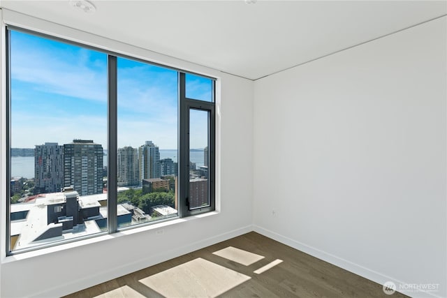 2510 6th Ave Unit 2306, Seattle, WA 98121 - spare room featuring wood finished floors and a view of city