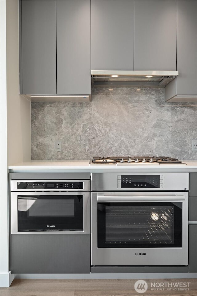 2510 6th Ave Unit 2306, Seattle, WA 98121 - kitchen with stainless steel oven, gray cabinets, and modern cabinets