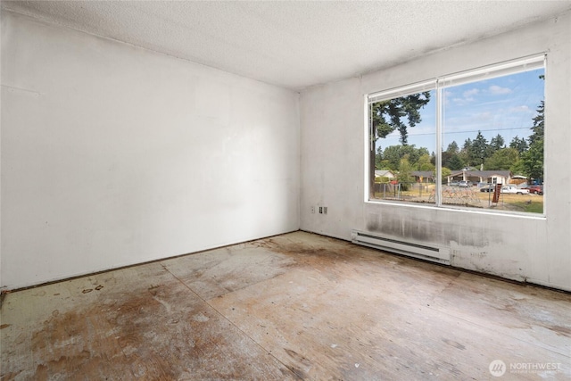 10423 13th Avenue Ct S, Tacoma, WA 98444 - unfurnished room with a baseboard radiator and a textured ceiling