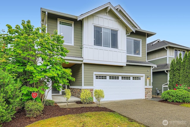 3720 195th Pl SE, Bothell, WA 98012 - view of front of house featuring board and batten siding, stone siding, an attached garage, and driveway