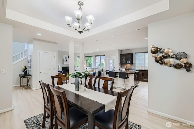 3720 195th Pl SE, Bothell, WA 98012 - dining space with light wood-type flooring, a tray ceiling, a chandelier, and recessed lighting