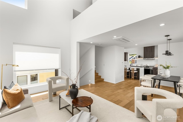 930 23rd Ave, Seattle, WA 98122 - living room featuring light wood-type flooring, stairway, and recessed lighting