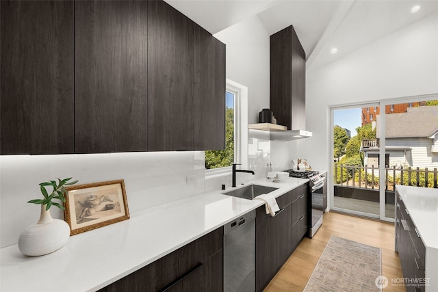 930 23rd Ave, Seattle, WA 98122 - kitchen featuring stainless steel appliances, wall chimney range hood, modern cabinets, light countertops, and light wood-style flooring