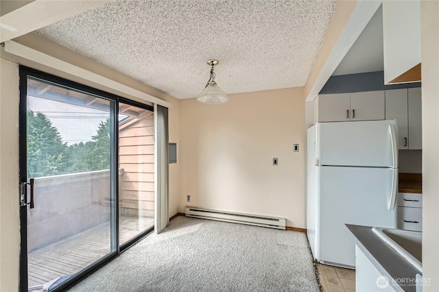 4802 S 187th Pl Unit A305, Seatac, WA 98188 - unfurnished dining area with a baseboard radiator and a textured ceiling
