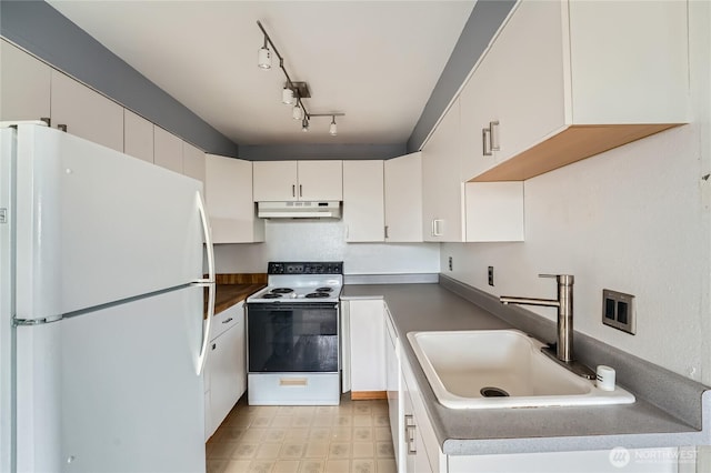 4802 S 187th Pl Unit A305, Seatac, WA 98188 - kitchen featuring white appliances, under cabinet range hood, dark countertops, white cabinetry, and light floors