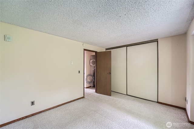 4802 S 187th Pl Unit A305, Seatac, WA 98188 - unfurnished bedroom with a textured ceiling, a closet, and light carpet