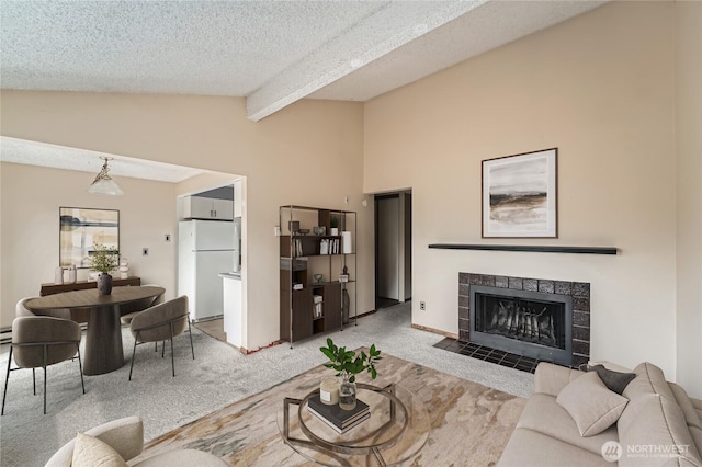 4802 S 187th Pl Unit A305, Seatac, WA 98188 - living area with carpet flooring, a tile fireplace, and a textured ceiling