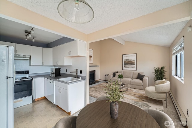 4802 S 187th Pl Unit A305, Seatac, WA 98188 - kitchen featuring white appliances, under cabinet range hood, a baseboard heating unit, white cabinetry, and open floor plan