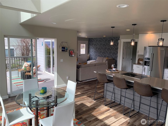 217 San Remo Ln, Chelan, WA 98816 - dining space with an accent wall, wood finished floors, and recessed lighting