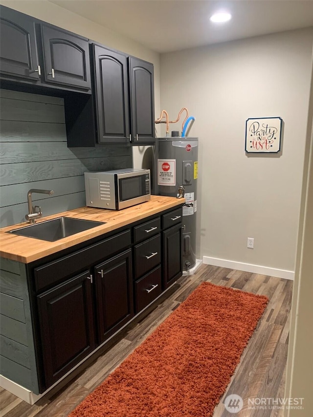 217 San Remo Ln, Chelan, WA 98816 - kitchen featuring stainless steel microwave, butcher block counters, electric water heater, wood finished floors, and recessed lighting