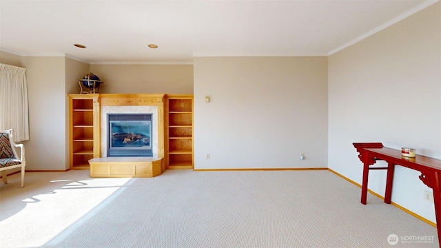 424 14th St # 202, Bellingham, WA 98225 - unfurnished living room featuring carpet floors, ornamental molding, and a tiled fireplace