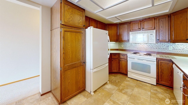 424 14th St # 202, Bellingham, WA 98225 - kitchen with white appliances, brown cabinetry, light countertops, and backsplash