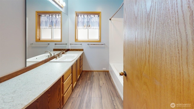 424 14th St # 202, Bellingham, WA 98225 - bathroom featuring vanity, wood finished floors, and shower / bathtub combination