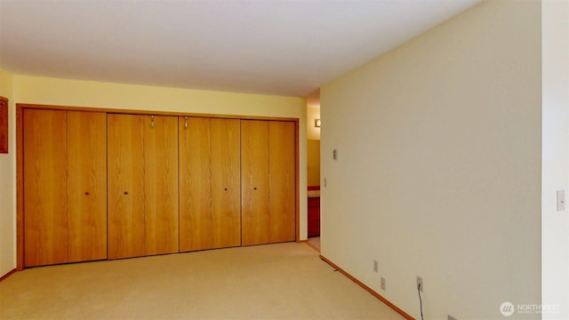 424 14th St # 202, Bellingham, WA 98225 - unfurnished bedroom featuring light carpet and a closet