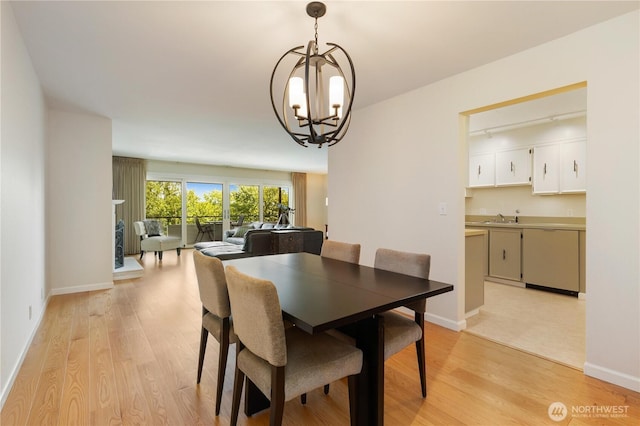 2565 Dexter Ave N Unit 103, Seattle, WA 98109 - dining room featuring a chandelier and light wood-style floors