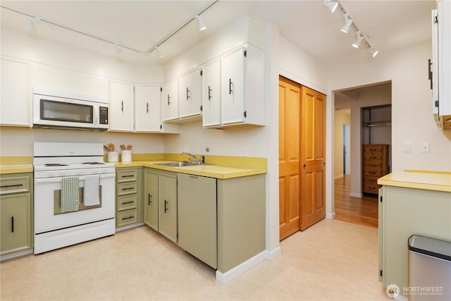 2565 Dexter Ave N Unit 103, Seattle, WA 98109 - kitchen with white appliances, rail lighting, light countertops, and light flooring