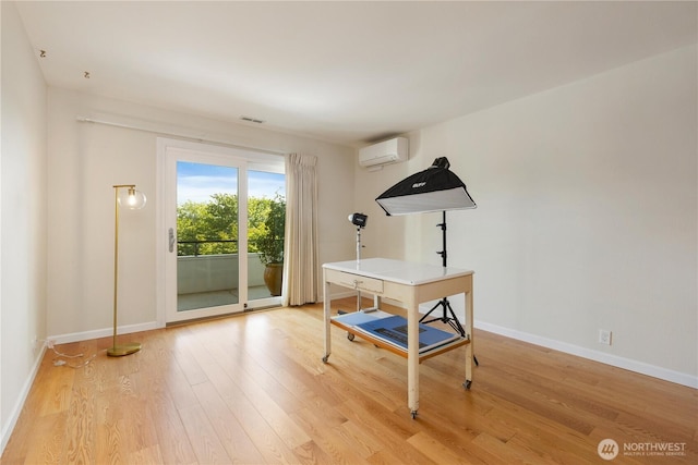 2565 Dexter Ave N Unit 103, Seattle, WA 98109 - home office with an AC wall unit and light wood-style flooring