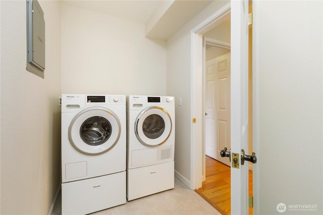 2565 Dexter Ave N Unit 103, Seattle, WA 98109 - laundry room with washing machine and dryer, electric panel, and light wood-style floors