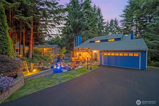 20814 28th Ave SE, Bothell, Bothell, WA 98021 - view of front of house with board and batten siding, a garage, asphalt driveway, a chimney, and roof with shingles