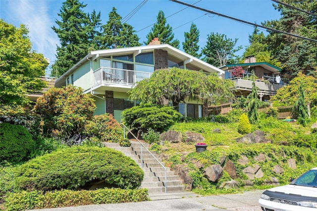 3421 23rd Ave W, Seattle, WA 98199 - view of front of home with brick siding, stairway, and a chimney