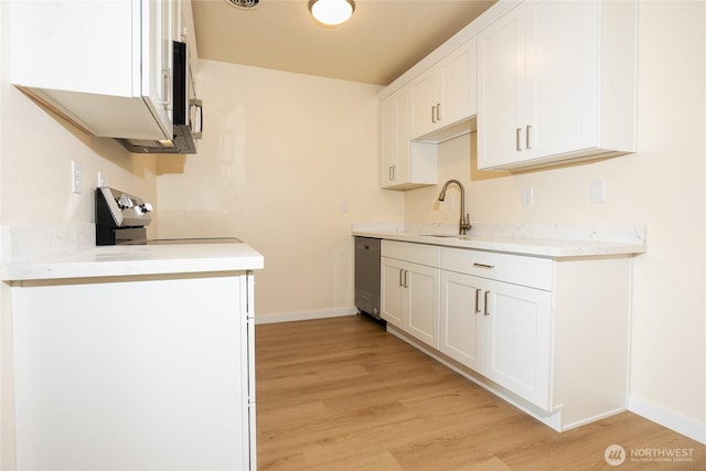 3421 23rd Ave W, Seattle, WA 98199 - kitchen featuring stainless steel appliances, light wood-style floors, and light countertops