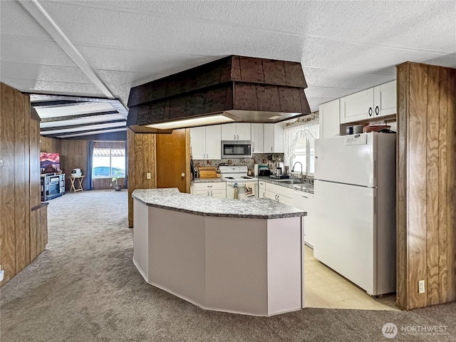 1385 Samuel Dr, Walla Walla, WA 99362 - kitchen with white appliances, light colored carpet, wood walls, white cabinets, and light countertops