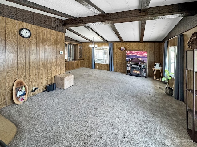 1385 Samuel Dr, Walla Walla, WA 99362 - living room featuring wood walls, healthy amount of natural light, carpet, a chandelier, and a glass covered fireplace