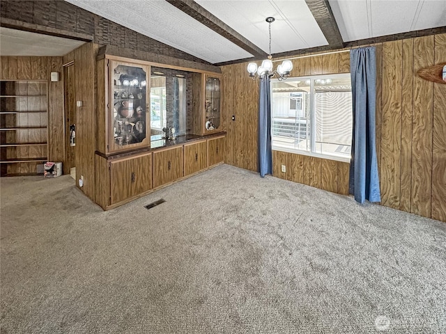 1385 Samuel Dr, Walla Walla, WA 99362 - unfurnished dining area with wood walls, carpet flooring, and a chandelier