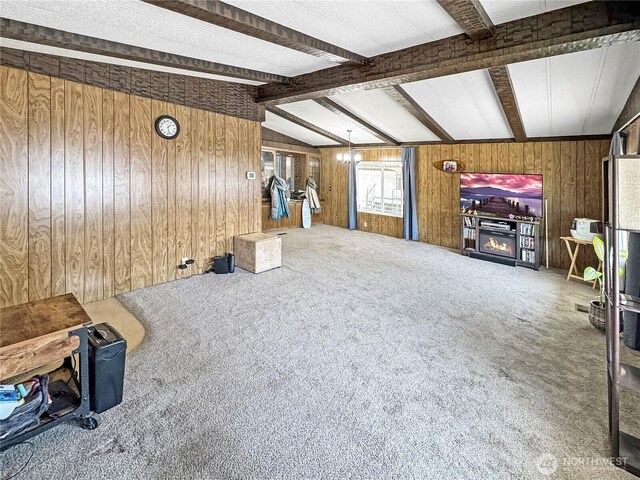 1385 Samuel Dr, Walla Walla, WA 99362 - unfurnished living room featuring wood walls, carpet floors, and a chandelier