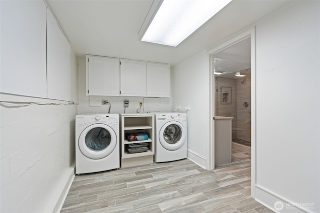 2322 Browns Point Blvd NE, Tacoma, WA 98422 - washroom with washer and clothes dryer, cabinet space, and light wood finished floors