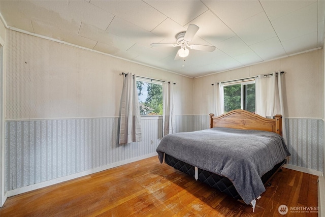 2991 Main St, Custer, WA 98240 - bedroom featuring wallpapered walls, wood-type flooring, wainscoting, ornamental molding, and a ceiling fan