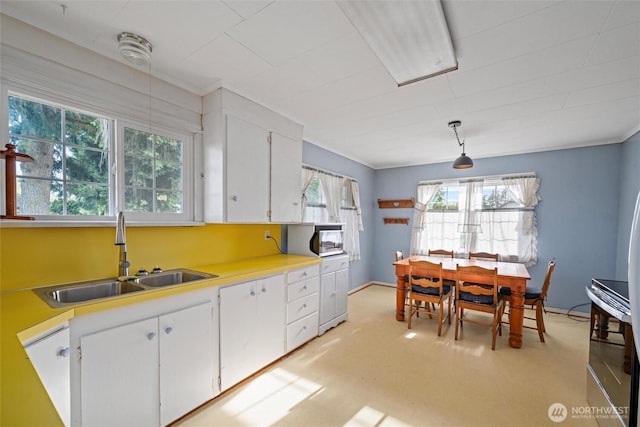 2991 Main St, Custer, WA 98240 - kitchen with white cabinets, electric stove, light countertops, hanging light fixtures, and ornamental molding