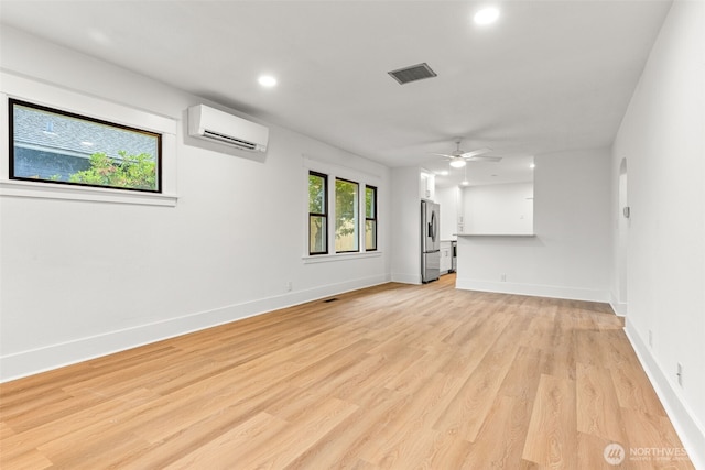1816 S Adams St, Tacoma, WA 98405 - unfurnished living room with a wall unit AC, recessed lighting, light wood-style floors, and ceiling fan