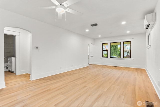 1816 S Adams St, Tacoma, WA 98405 - unfurnished room with a wall mounted air conditioner, arched walkways, light wood-style floors, recessed lighting, and a ceiling fan