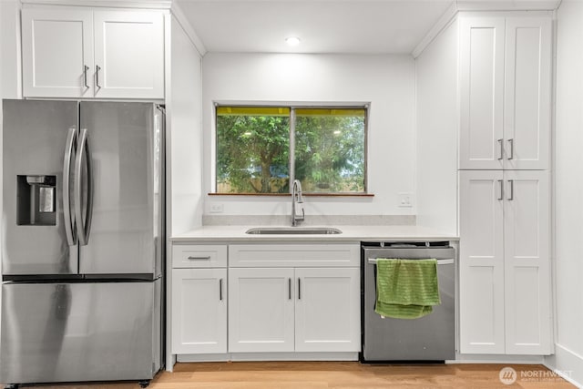 1816 S Adams St, Tacoma, WA 98405 - kitchen with appliances with stainless steel finishes, light countertops, white cabinetry, light wood-style flooring, and recessed lighting