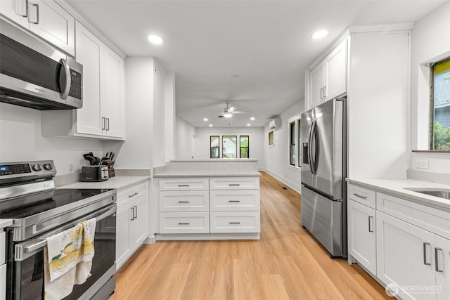 1816 S Adams St, Tacoma, WA 98405 - kitchen with appliances with stainless steel finishes, recessed lighting, light wood-type flooring, a ceiling fan, and light countertops