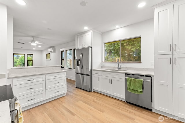 1816 S Adams St, Tacoma, WA 98405 - kitchen featuring appliances with stainless steel finishes, a wall mounted AC, light countertops, a ceiling fan, and white cabinetry